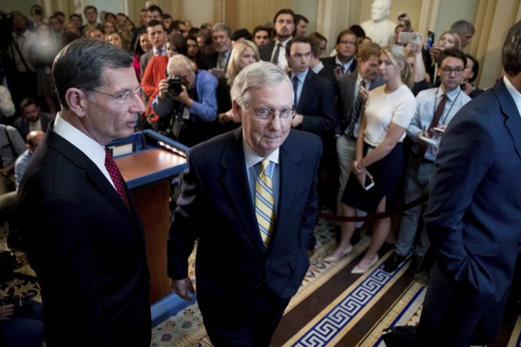 Senate Majority Leader Mitch McConnell, R-Ky., joined by Sen. John Barrasso, R-Wyo., left, shown after announcing that he was delaying a vote on the Republican health care bill on Tuesday, is aiming to revise the bill by Friday, aides say.
