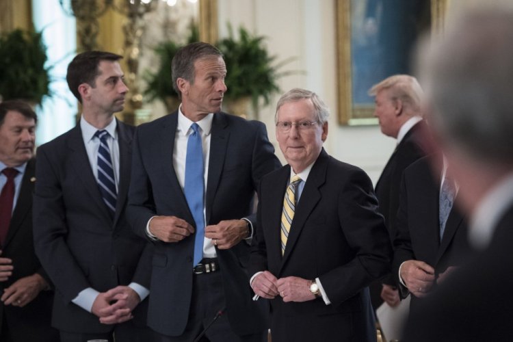 From left, Sens. Tom Cotton, R-Ark., John Thune, R-S.D., and Mitch McConnell, R-Ky., stand as President Trump arrives for a meeting with Republican senators about health care at the White House on Tuesday.