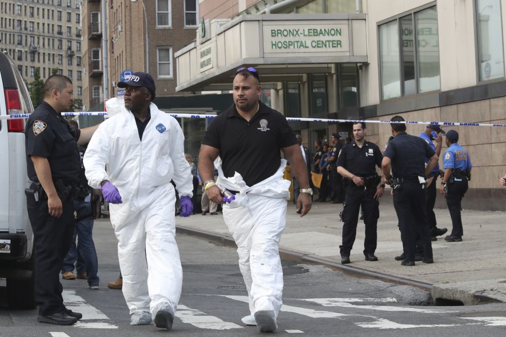 Police officers with the Forensics Unit leave Bronx Lebanon Hospital after a doctor who used to work there opened fire with an AR-15 and then took his own life there on Friday in New York.