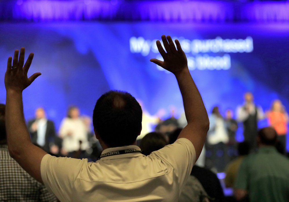 Conservative Christians pray during the Southern Baptist Convention's annual meeting last month in Phoenix. Research suggests that the nonsecular world is evolving with the secular when it comes to same-sex issues and overall support for LGBT issues.