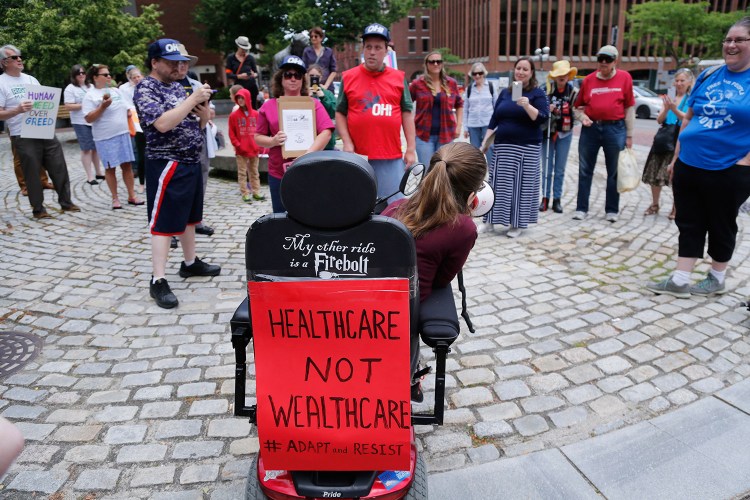 Kingsley Floyd, a Waynflete School graduate who was arrested at a protest in front of Senate Majority Leader Mitch McConnell's office last week, speaks a rally for health care Wednesday at Lobsterman's Park in Portland. She said people with disabilities need Medicaid funding to be able to live independently.
