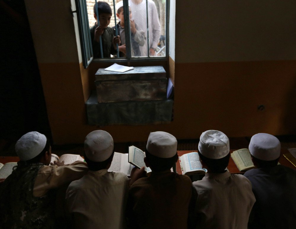 Afghan boys read the Quran during the Muslim holy month of Ramadan at a mosque in Kabul. In central Maine, Muslim families are in the minority and school calendars allow time off for only Christian holidays.