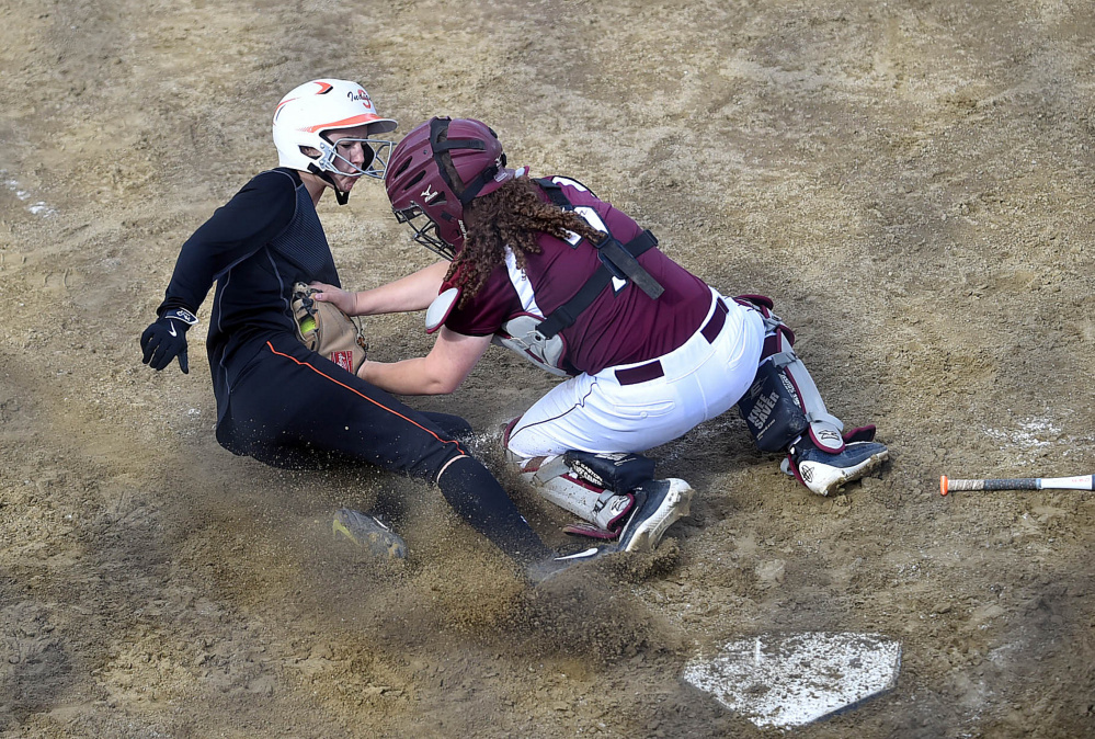 Edward Little catcher Emma Lashua tags out Skowhegan runner Emma Duffy during the Kennebec Valley Athletic Conference Class A title game Friday.