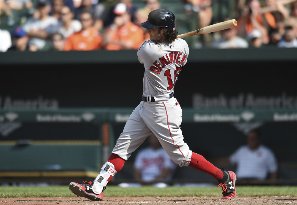Boston Red Sox outfielder Andrew Benintendi follows through on a single against the Orioles in the ninth inning Sunday in Baltimore.