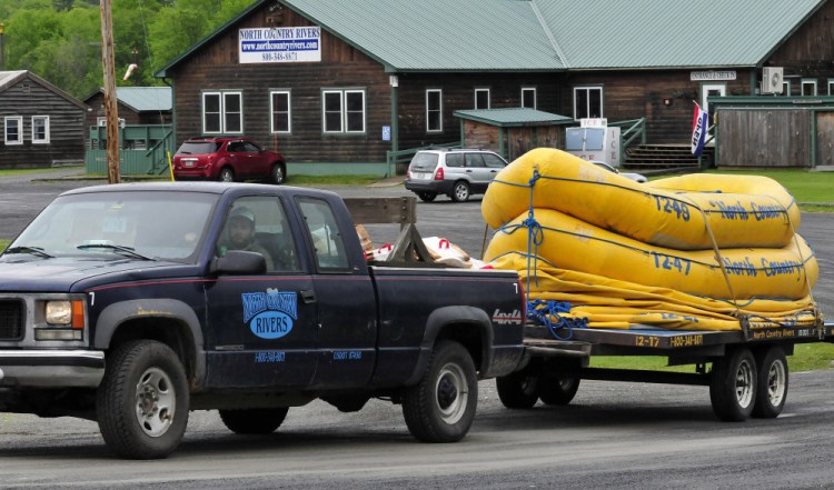 A North Country Rivers employee hauls a trailer full of white water rafts while leaving the base lodge of the company in Bingham on Monday. The Maine Warden Service continues to investigate the death of Richard Sanders last Saturday after the raft he was in flipped over on the Dead River.