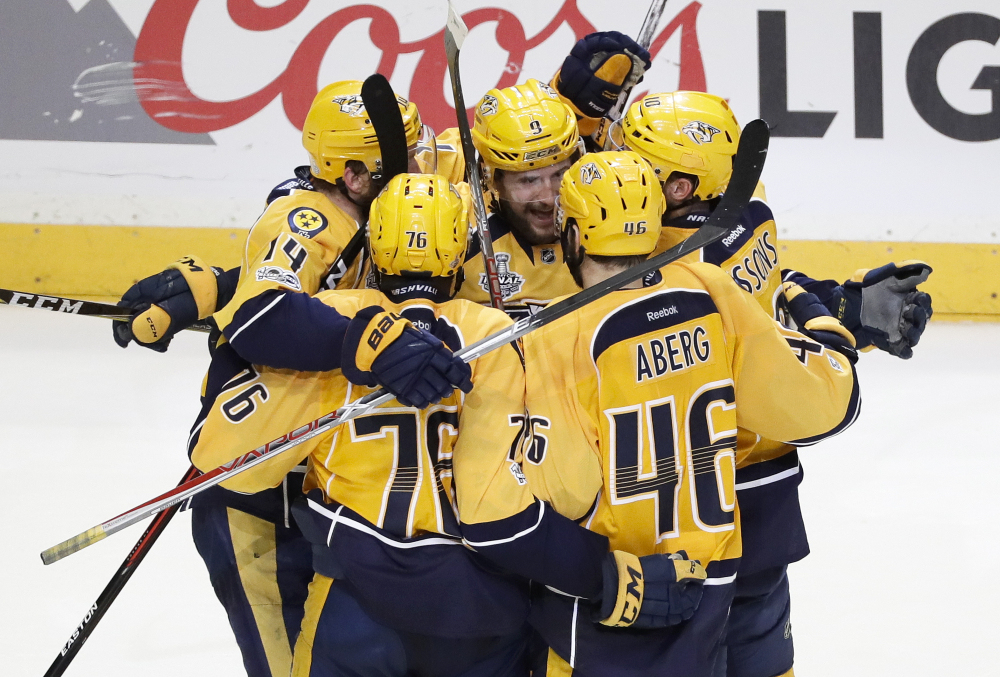 Nashville Predators left wing Filip Forsberg (9) is congratulated after scoring an empty net goal against the Penguins during the third period in Game 4 of the Stanley Cup Final on Monday.
