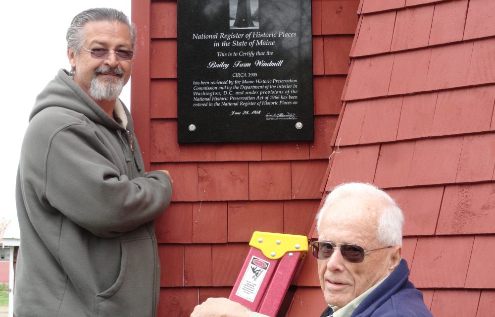Stan Quint, left, and Mitchell Quint installed a plaque about the historic Bailey Farm Windmill on May 12 at the North Anson windmill.