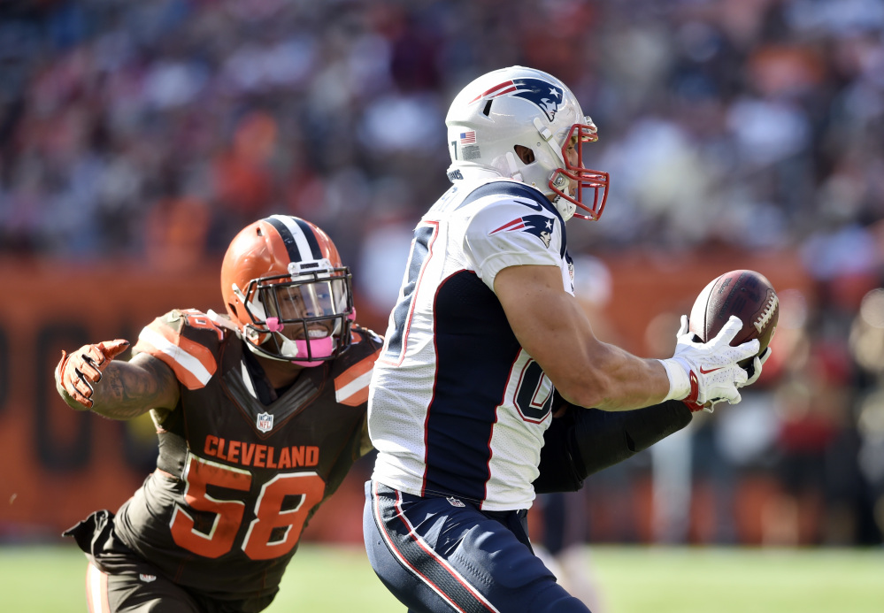 New England Patriots tight end Rob Gronkowski, right, makes a catch against Cleveland inside linebacker Christian Kirksey in the second half of an Oct. 16 game last season.