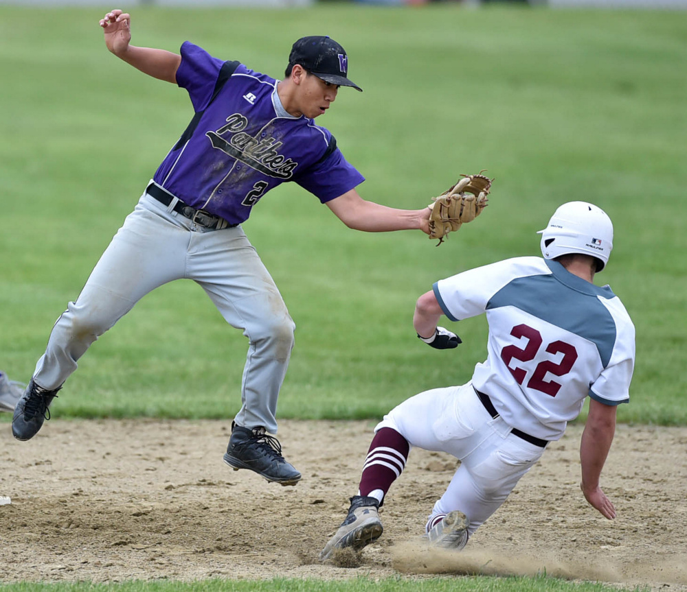 Waterville's Chay Phelps, left, leaps for the high throw to tag out Foxcroft runner Billy Brock during a Class B North prelim game Tuesday.