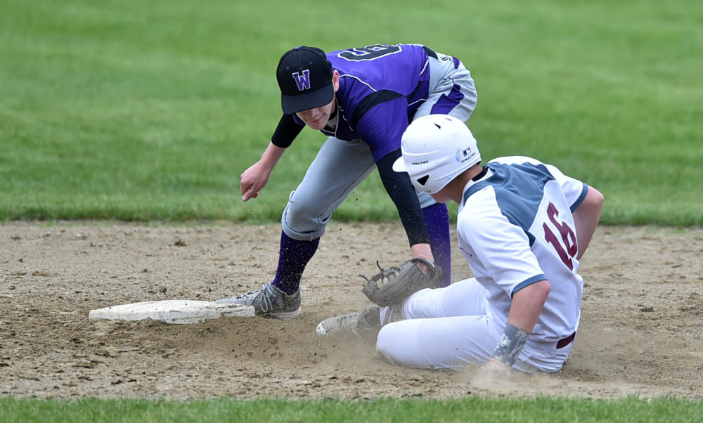 Waterville's David Barre tags out Foxcroft runner Ryan Vienneau at second base  during a Class B North prelim game Tuesday