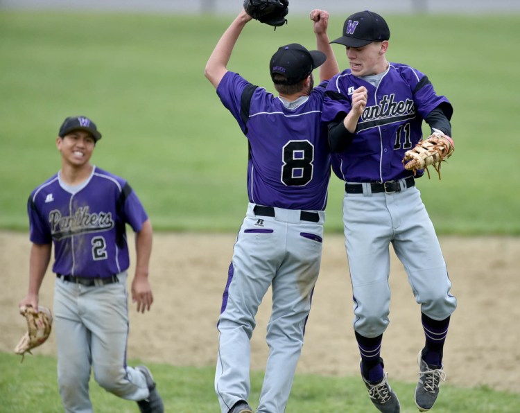 Waterville teammates Cody Pellerin (8) and Jackson Aldrich (11) celebrate after they sank Foxcroft Academy 3-0 in a Class B North prelim game Tuesday.