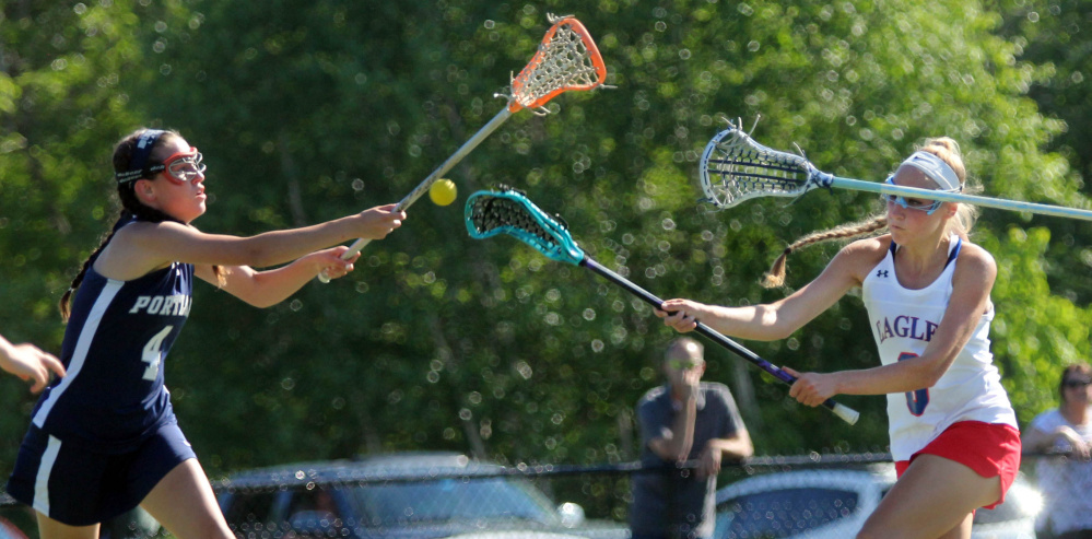Messalonskee's Ally Turner fires a shot on net as Portland's Morgan Kierstead defends during the first half of a Class A North girls lacrosse quarterfinal Wednesday at Thomas College.
