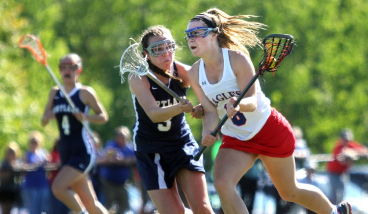 Messalonskee's Lauren Pickett moves past Portland defender Elena Clifford  during the first half of a Class A North girls lacrosse quarterfinal Wednesday at Thomas College.