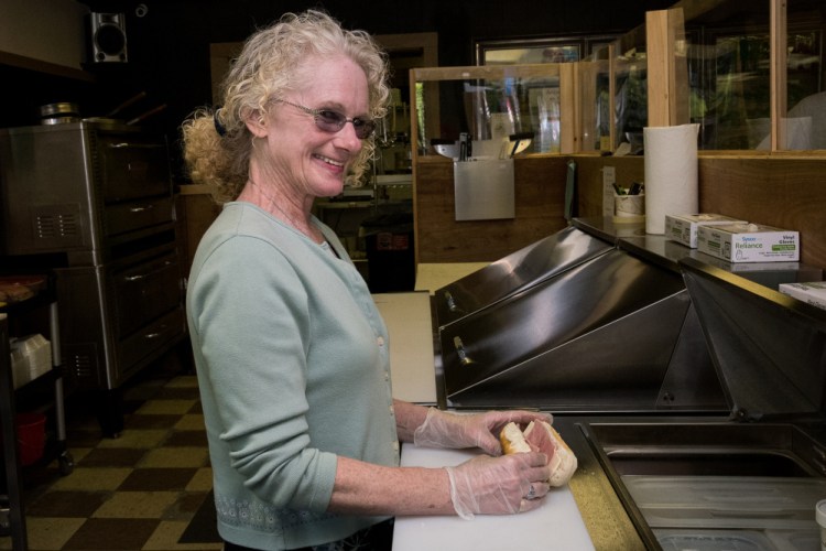 Jewell's Market on Main Street in Readfield features homemade food, pizza and submarine sandwiches. Owner Sherri Jewell is shown here Wednesday making a ham sandwich.