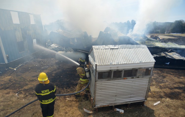 Firefighters from Weeks Mills, China, South China and Windsor battle a structure fire April 15 on Neck Road in South China. China selectmen at a Thursday morning meeting voted to pay officers stipends and emergency responders an hourly wage.