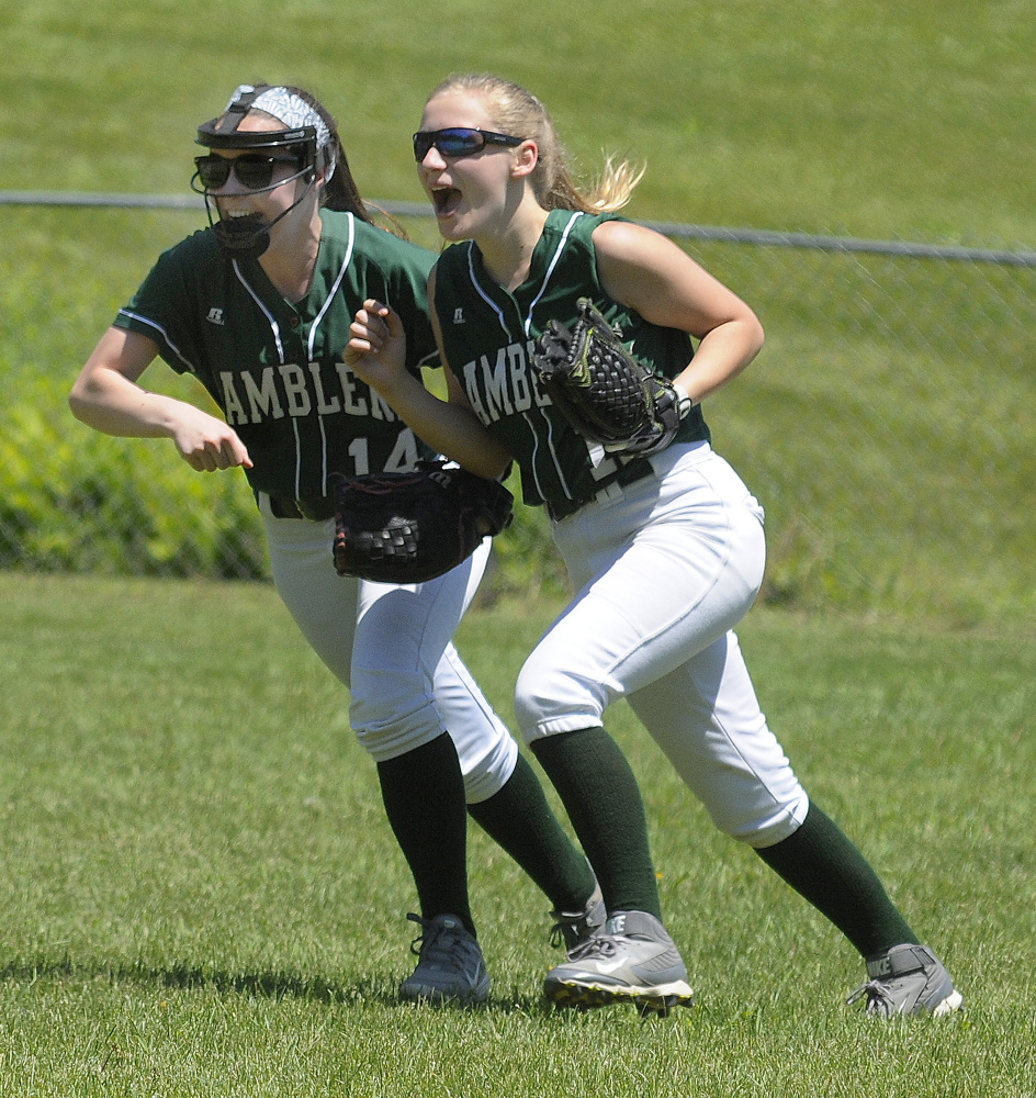 Staff photo by Joe Phelan 
 Winthrop second baseman Moriah Hajduk, left, and outfielder Maria Dostie celebrate after Dostie caught a fly ball to record the last out of a Class C South semiinal game against rival Monmouth on Saturday.