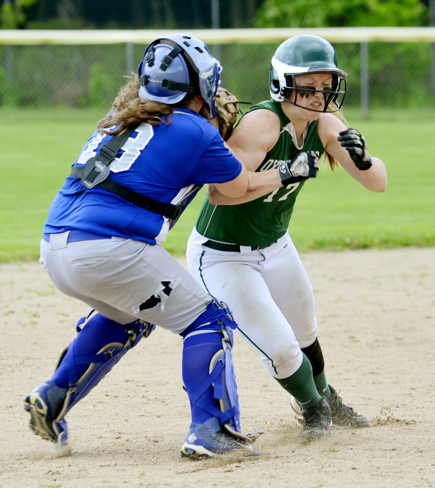 Lawrence catcher Haley Holt attempts to run down Oxford Hills runner Hannah Kenney between second and third base in the sixth inning of a Class A North semifinal game Saturday in South Paris.