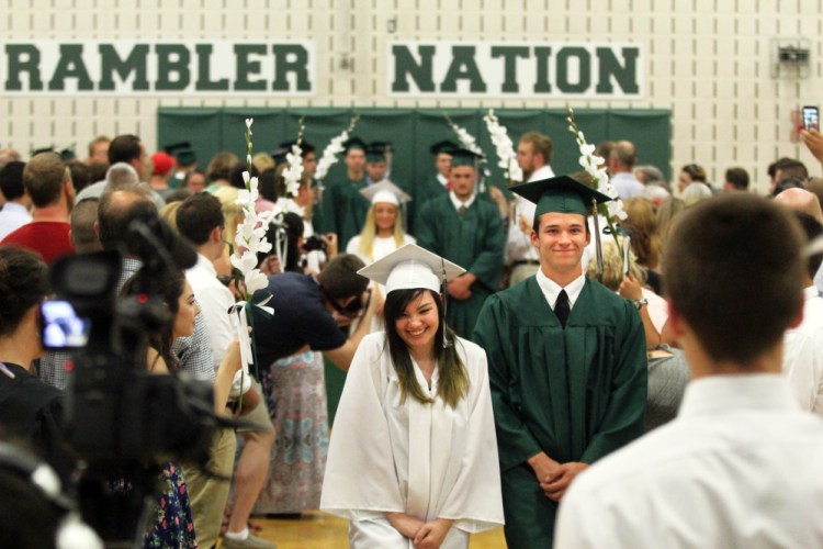 Alyxis Torrez and Bennett Brooks march in the processional during commencement exercises at Winthrop High School on Sunday.