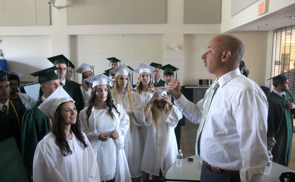 Winthrop High School Principal Keith Morin gives some last-minute instructions prior to graduation exercises on Sunday.