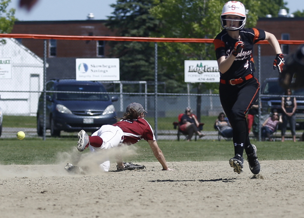 Bangor shortstop Emma Payne can't get to this grounder as Skowhegan runner Sydney Reed bolts for third base during an A North semifinal game  Saturday. The Indians will play Oxford Hills in the regional final.