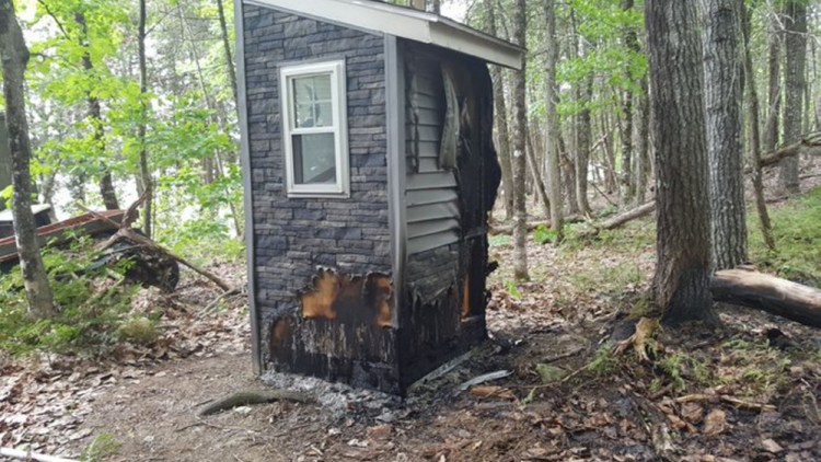 State forest rangers and firefighters from several departments, including Canaan's, fought a fire on Sibley Pond, where two buildings were damaged Tuesday.
