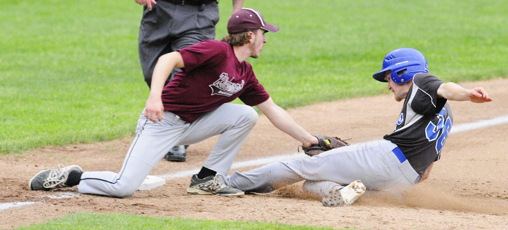 Staff photo by Joe Phelan 
 Richmond third baseman Brady Johnson tags out Searsport's Liam MacMillan during the Class D South regional final Tuesday at St. Joseph's College in Standish.