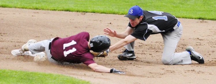 Staff photo by Joe Phelan 
 Richmond's Nate Kendrick, left, safely slides into second avoiding the tag of Searsport shortstop Colby Snow during the Class D South regional final Tuesday at St. Joseph's College in Standish.