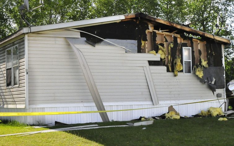 Police tape surrounds a mobile home at 13 Gold St. in the Evergreen Terrace mobile home park in Clinton. The mobile home was damaged by a fire that broke out late Tuesday night.