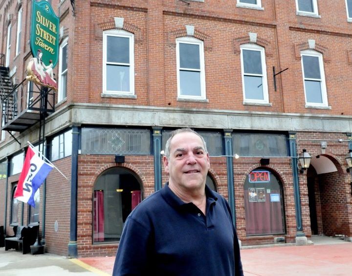 Charlie Giguere stands outside his Silver Street Tavern and renovated apartment building in April 2015 in Waterville. Gigure, president of the board of directors of Waterville Main Street, thinks the organization will not be funded by the city and will lose its standing as an organization.