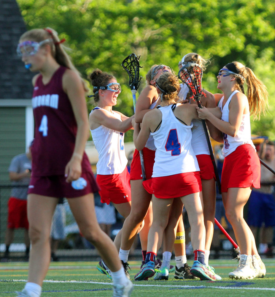 The Messalonskee High School girls lacrosse team celebrates its 7-6 overtime win over Windham in the Class A North championship game Wednesday at Thomas College.