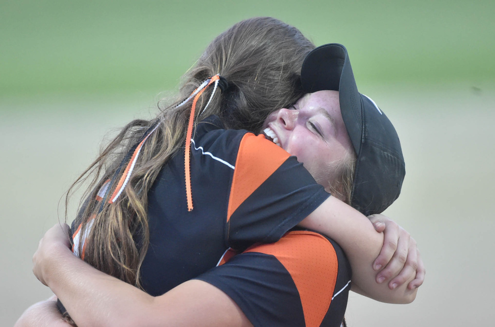Skowhegan pitcher Ashley Alward embraces Julia Steeves after the Indians won the Class A North championship game Wednesday night in Augusta.