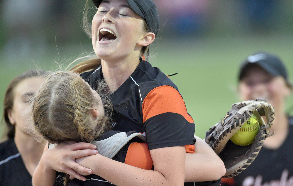 Skowhegan pitcher Ashley Alward jumps into the arms of catcher Sydney Reed after the Indians defeated Oxford Hills 5-4 in the Class A North championship game at Cony High School on Wednesday.