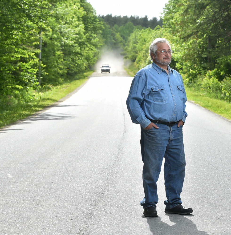 Bruce Keezer stands at 129 Goodrich Road in Clinton, where he lives, on Thursday. Keezer relies on the Kennebec Valley Community Action Program to get to Waterville from his rural home in Clinton for medicine and other supplies.