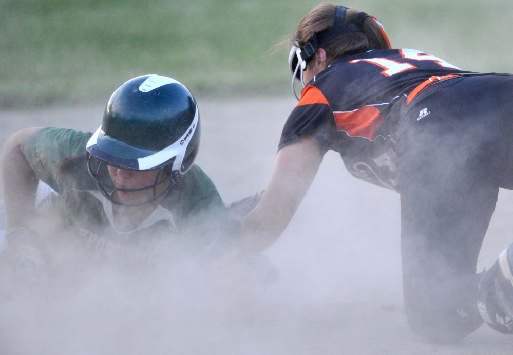 Oxford Hills runner Madison Day slides safely into third base before Skowhegan infielder Lindsey Warren can apply the tag during the Class A North title game Wednesday night in Augusta.