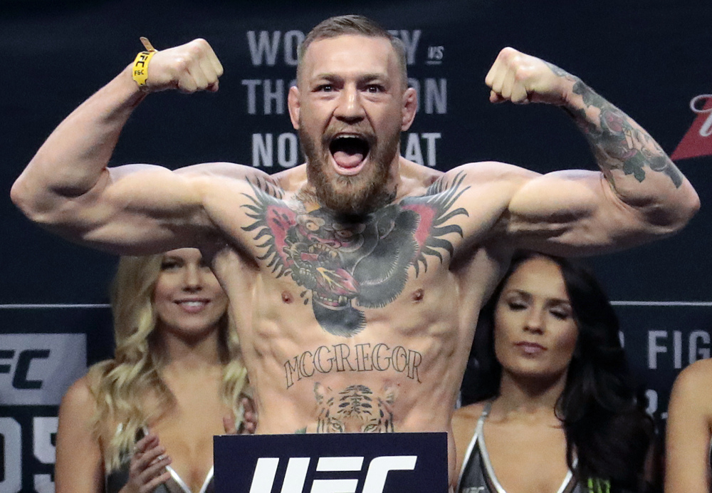 In this Nov. 11, 2016 photo, Conor McGregor stands on a scale during the weigh-in event for his fight against Eddie Alvarez in UFC 205 mixed martial arts at Madison Square Garden in New York.