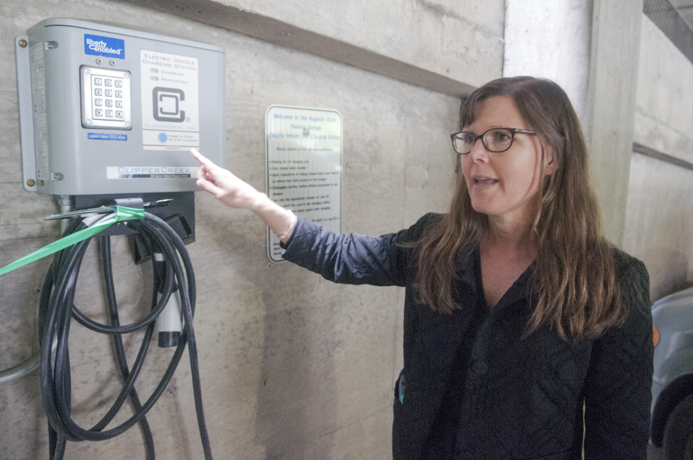Jennifer Brennan, of the Greater Portland Council of Governments, talks about the new chargers for electric cars Friday in the State House parking garage in Augusta.