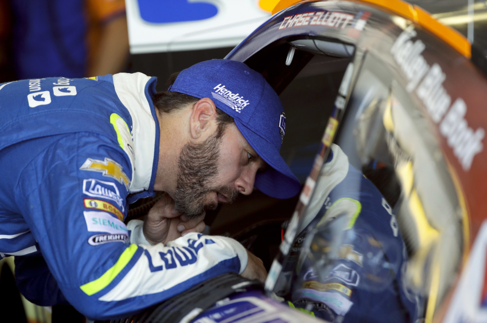 In this June 9 photo, Jimmie Johnson talks with teammate Chase Elliott in the garage during practice for the Pocono 400.