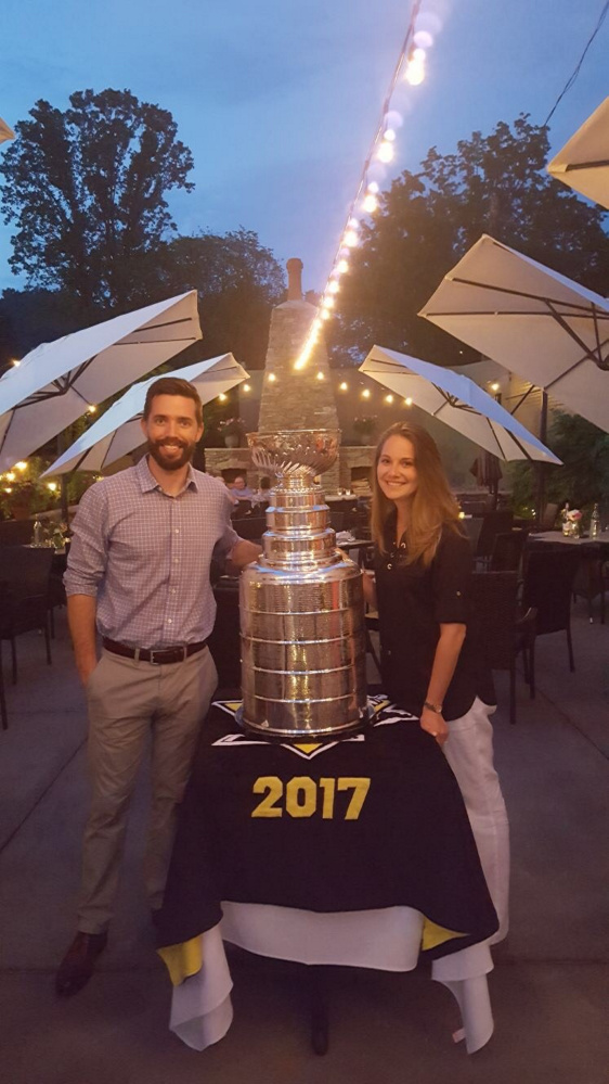 Contributed photo 
 Andy Saucier, left, and his fiance Kate McAuliff stand with the Stanley Cup trophy recently.