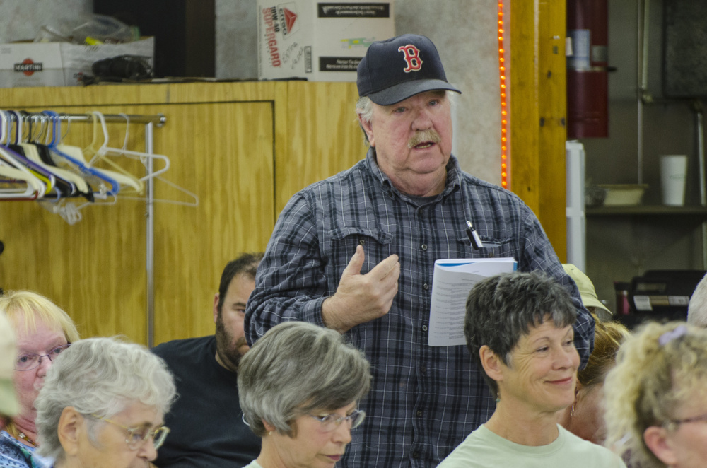Litchfield voters show their approval of a motion on the floor Saturday during Town Meeting, held at the Sportsman's Club in Litchfield.