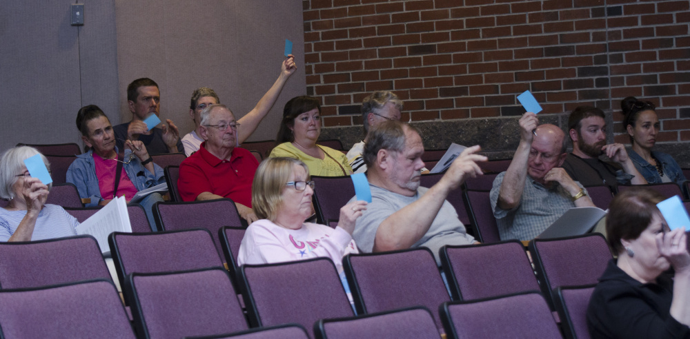 Farmingdale residents vote Saturday during Town Meeting at Hall-Dale High School in Farmingdale.
