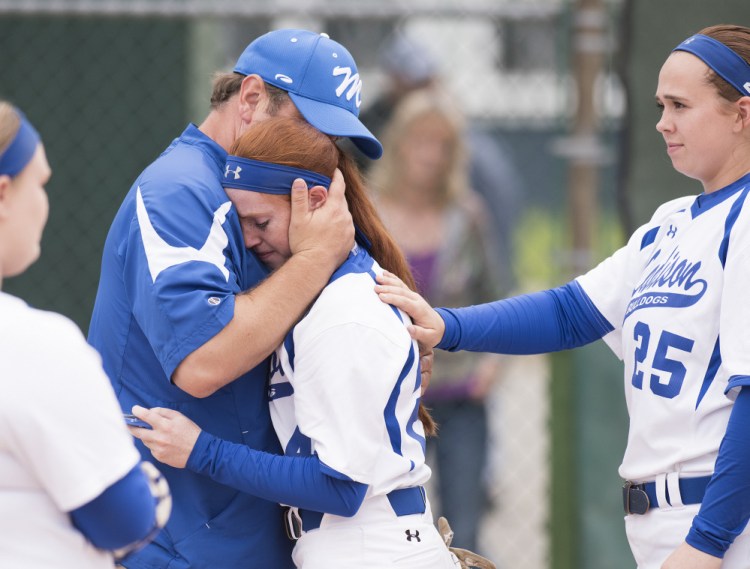 Kevin Bennett photo 
 Madison's Ashley Emery is comforted by head coach Chris LeBlanc and teammate Victoria Blauvet after losing to Bucksport in the Class C state championship Saturday in Brewer.
