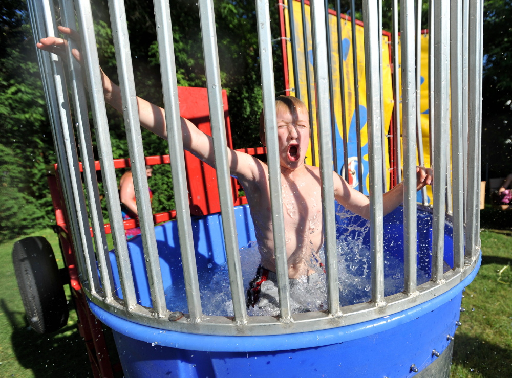 Dana Paradis, 12, gasps for air after being dunked in the dunk tank during the 7th Annual North End Night on Drummond Avenue in Waterville on June 27, 2014. The 10th edition of North End Night will be held Wednesday in Dave Quirion Park on Drummond Avenue.