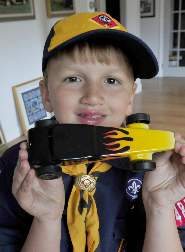 Cub Scout Trevor Russell, 8, of North Anson, shows his entry in the 2017 World Championship Pinewood Derby competition on Wednesday. The competition is being held in Times Square in New York City.