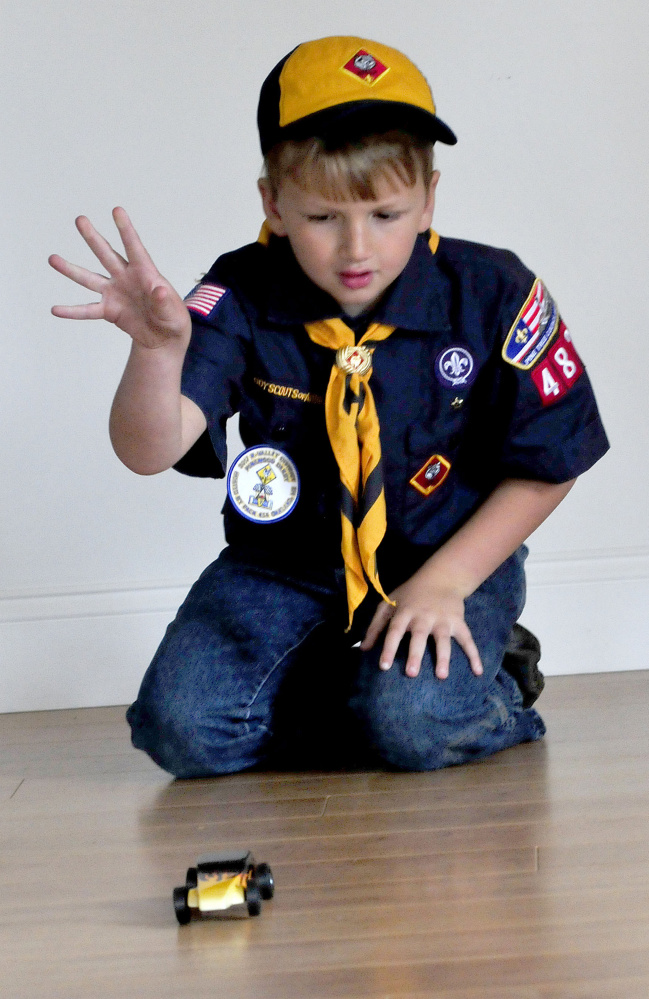 Cub Scout Trevor Russell, 8, of North Anson, gives his entry in the 2017 World Championship Pinewood Derby competition a spin on Wednesday. The competition is being held in Times Square in New York City.