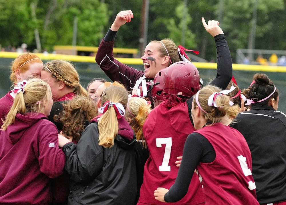 Richmond's Jamie Plummer leaps above her Bobcat teammates as they celebrate their 3-2 victory over Buckfield in the 2011 Western Class D championship game at St. Joseph's College in Standish.
