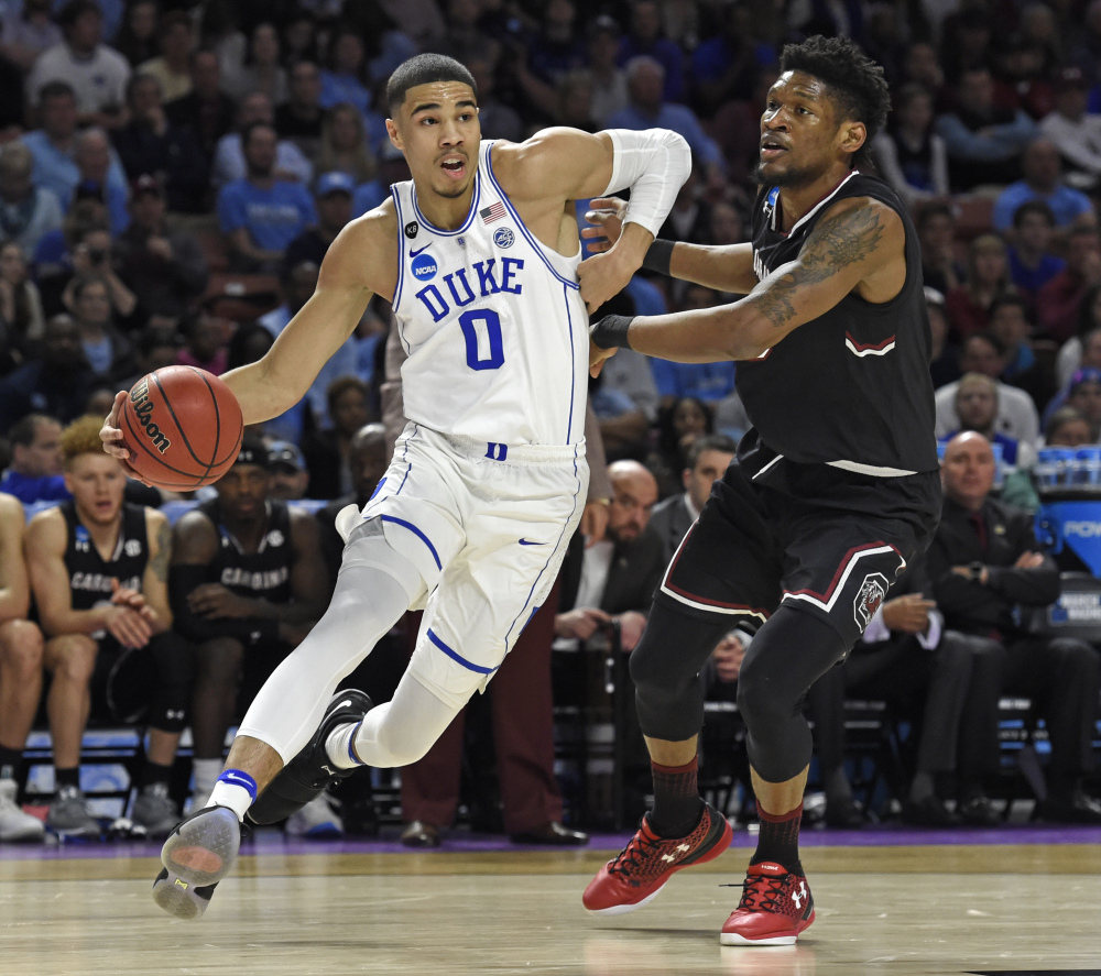 In this March 19 photo, Duke's Jayson Tatum, left, drives past South Carolina's Chris Silva during the first half of a second-round game of the NCAA tournament, in Greenville, South Carolina.