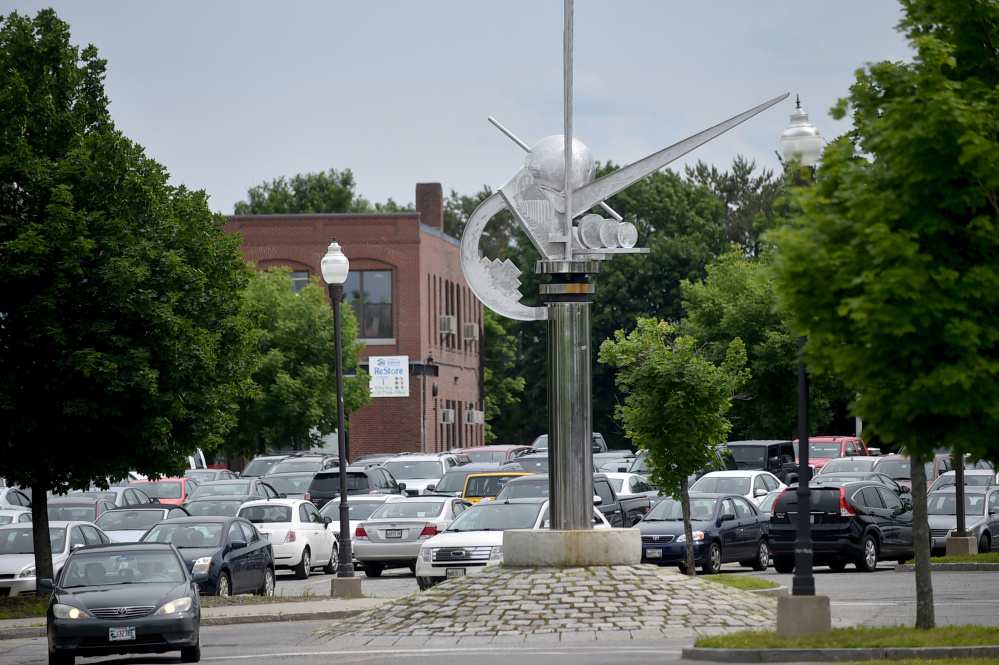 The sculpture "Ticonic" stands in the midst of parked cars Thursday in The Concourse in Waterville.