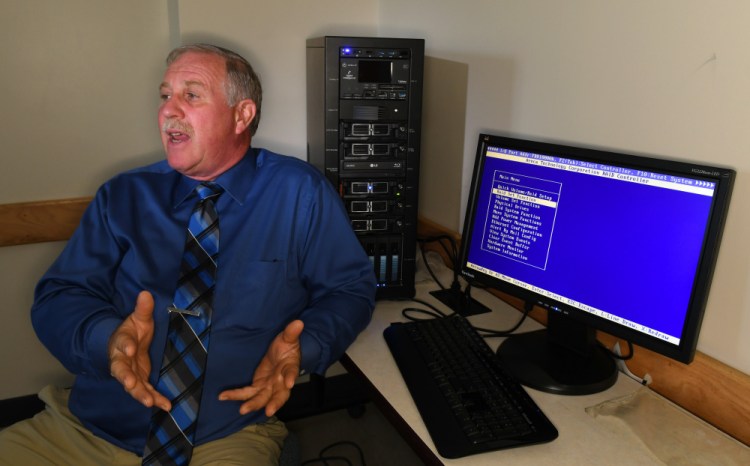 University of Maine at Augusta cybersecurity program director Henry Felch sits beside the Forensic Recovery of Evidence Device, known as FRED, on Wednesday in the new cybersecurity laboratory at the University of Maine at Augusta.