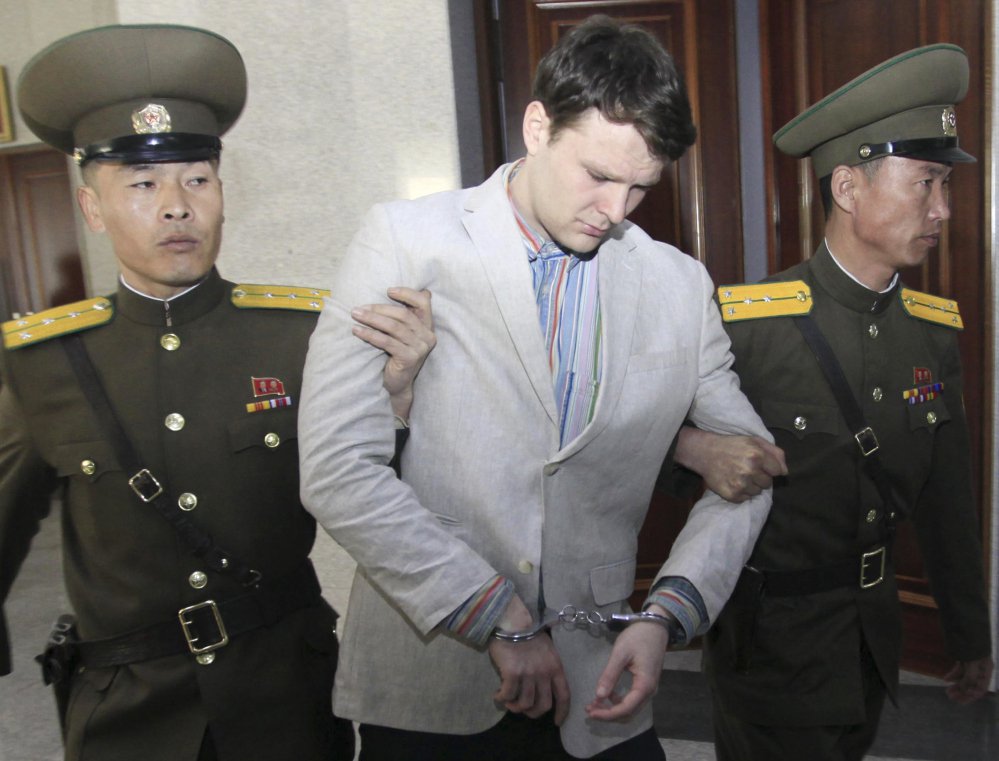 American student Otto Warmbier, center, is escorted at the Supreme Court in Pyongyang, North Korea, on March 16, 2016.