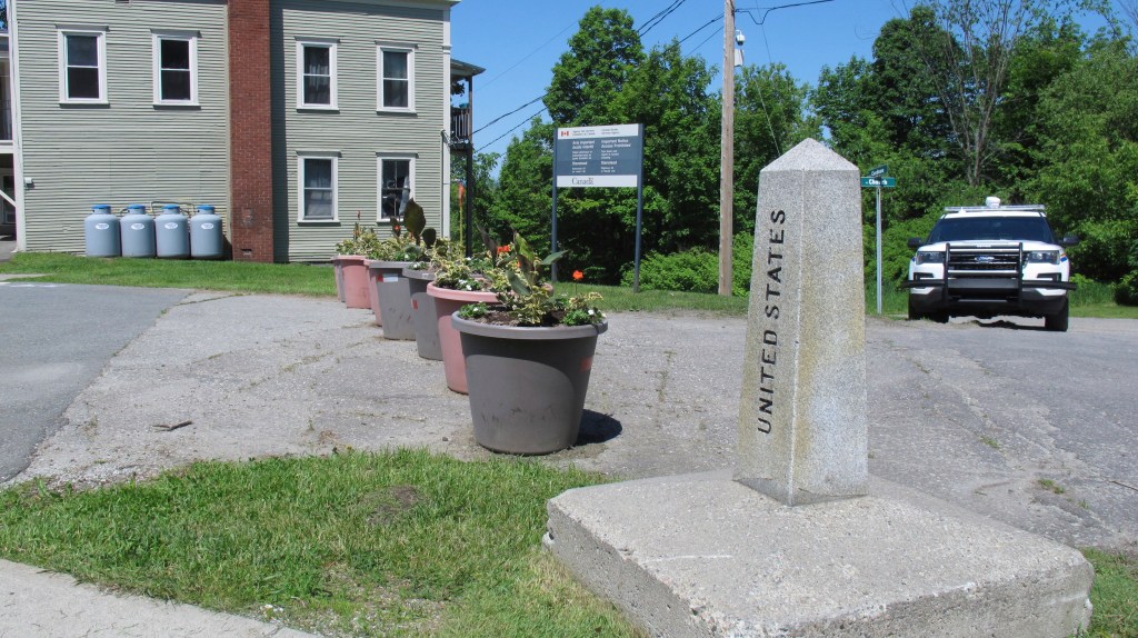 A border post and planters show the U.S.-Canadian border where it passes through an apartment building located in the two countries. 